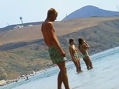 Sexy teeny babes topless on a beach get filmed by a voyeur camera