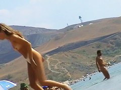 Sexy teeny babes topless on a beach get filmed by a voyeur camera