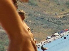 Sexy teeny babes topless on a beach get filmed by a voyeur camera