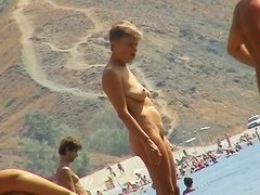 Sexy teeny babes topless on a beach get filmed by a voyeur camera
