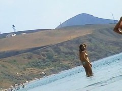 Sexy teeny babes topless on a beach get filmed by a voyeur camera