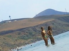 Sexy teeny babes topless on a beach get filmed by a voyeur camera