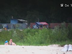 Two naked girls get their cute butts on beach voyeur camera