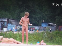 Two naked girls get their cute butts on beach voyeur camera