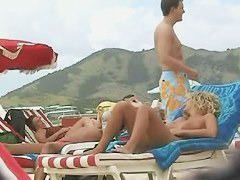 Beach beauties hang out naked below the sun