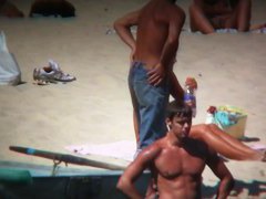 Horny naked brunette woman teasing her mates on the beach