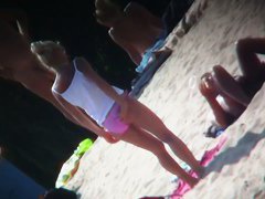 Beach voyeur vid features a hot blonde topless girl.