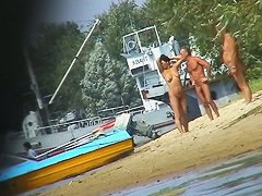 Hot beach voyeur video shows mature nudists enjoying each others company.