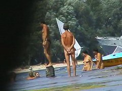 Hot beach voyeur video shows mature nudists enjoying each others company.