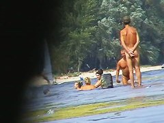 Hot beach voyeur video shows mature nudists enjoying each others company.