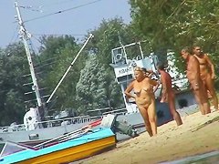 Hot beach voyeur video shows mature nudists enjoying each others company.