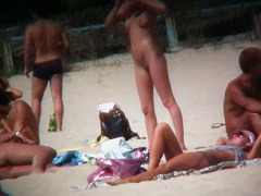 Intriguing, hot redhead in a nude beach video
