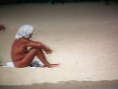 Intriguing, hot redhead in a nude beach video