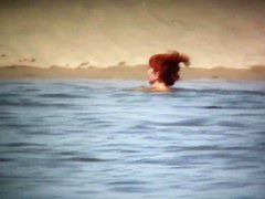 Intriguing, hot redhead in a nude beach video