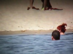 Intriguing, hot redhead in a nude beach video