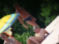 A voyeur beach video of a nude couple standing in the water