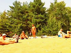 Wives and their husbands sunbathing at the nudist beach