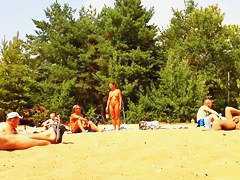 Wives and their husbands sunbathing at the nudist beach