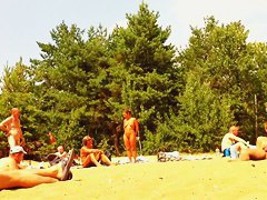 Wives and their husbands sunbathing at the nudist beach