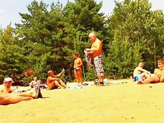 Wives and their husbands sunbathing at the nudist beach