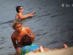 Bitches are swimming and standing on the sunny beach