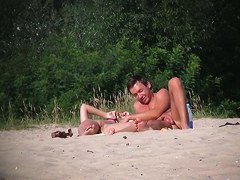 Erotic nude beach video of a couple carresing each other
