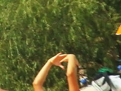 A luscious woman sunbathing in this nude beach voyeur video