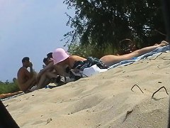 Hot dark haired girl and her friend in this beach spy cam video
