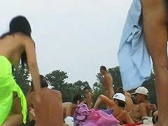 Hot dark haired girl and her friend in this beach spy cam video
