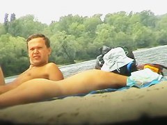 Babe with big natural boobs sunbathing at the nudist beach