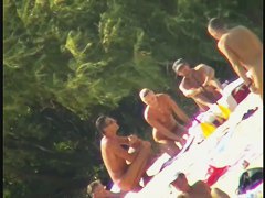 Blonde naked babe with shaved pussy on public beach nudist exposure