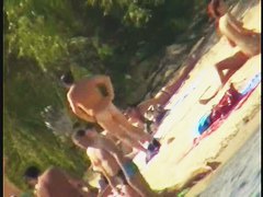Blonde naked babe with shaved pussy on public beach nudist exposure