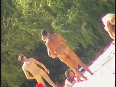 Blonde naked babe with shaved pussy on public beach nudist exposure