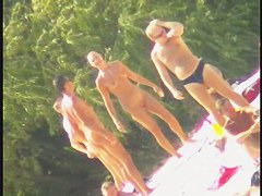 Blonde naked babe with shaved pussy on public beach nudist exposure