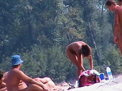 Perky breasted nude beach MILF filmed by a voyeur