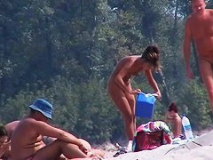 Perky breasted nude beach MILF filmed by a voyeur