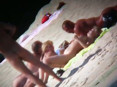 Mature babe with beautiful breasts gets all wet at nudist beach