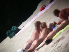 Mature babe with beautiful breasts gets all wet at nudist beach