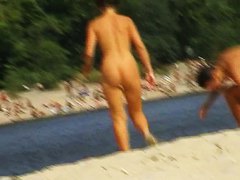 Voyeur preys on a juicy ass on the nudist beach