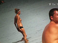 Sweet pussy of beach nudist girl spied between her legs