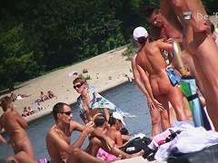 Sweet pussy of beach nudist girl spied between her legs