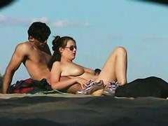 A sexy model couple on the beach voyeur video