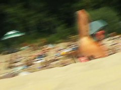 Beach voyeur gets his spy cam in action for a nudist shot