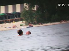 Hot nudist woman captured by a hidden beach camera