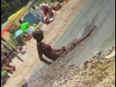 Sexy blonde chick is sitting naked by the sea and relaxing