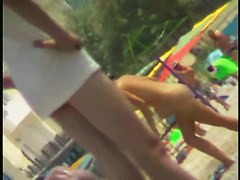 Sexy blonde chick is sitting naked by the sea and relaxing