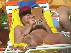 Hot video of a mature woman reading a book on a nudist beach