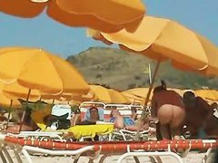 Hot video of a mature woman reading a book on a nudist beach