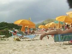 Hot video of a mature woman reading a book on a nudist beach