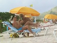 Hot video of a mature woman reading a book on a nudist beach